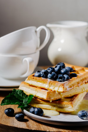 Viennese waffles with condensed milk and blueberries.の写真素材