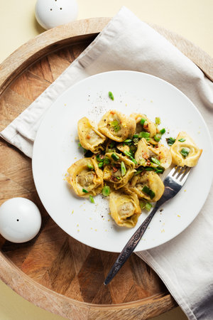Mushroom tortellini with butter and herbs, top view.の写真素材