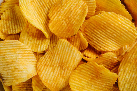 Wavy potato chips close-up, texture, background.の写真素材