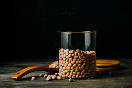 Jar of chickpeas beans on a dark background.の写真素材