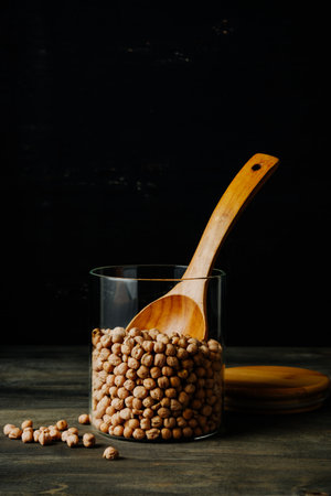 Jar of chickpeas beans on a dark background.の写真素材