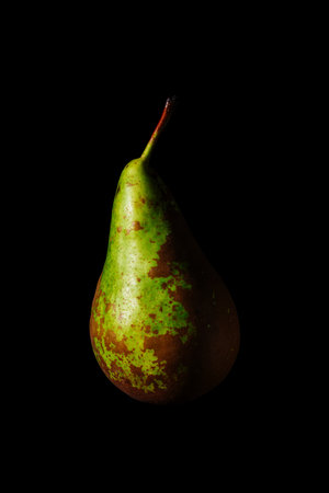 Green pear on black background close-up.の写真素材