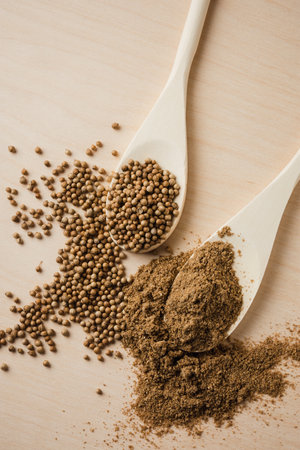 Coriander seeds on wooden background, top view.の写真素材