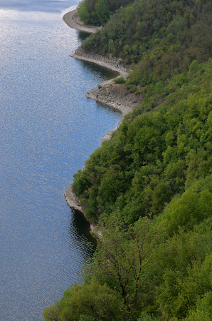 Ukraine. Sammer Karpaty Clouds. Coast, green Zigzag, green trees, blue waterの写真素材