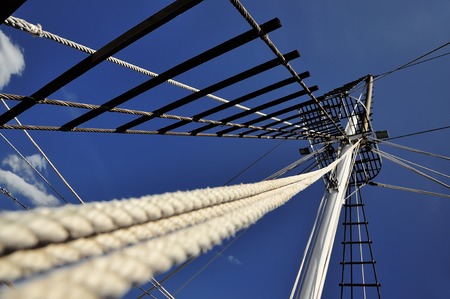 The mast of the ship, which goes to Mount Athos on a background of the blue sky