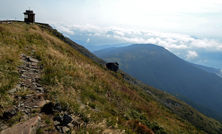 Ukraine. The peaks of the Carpathian Mountains. Mountain ranges covered with forests under blue cloudsの写真素材