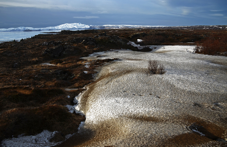 Sunrise against the background of mountainous, snowy, empty, picturesque landscapes of Icelandの写真素材