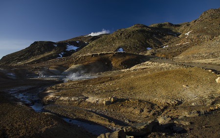 Iceland is a land of ice and fire. In the geothermal area Kerlingarfjoll one can see smoke and boiling fumaroles from the geothermal field as well as mountains covered by ice and snow.の写真素材