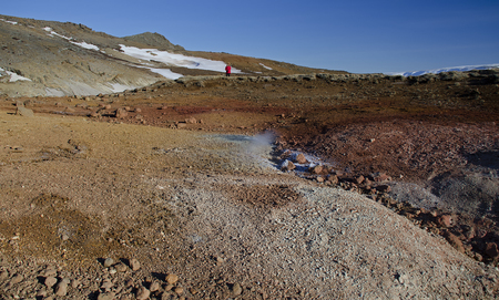 Iceland is a land of ice and fire. In the geothermal area Kerlingarfjoll one can see smoke and boiling fumaroles from the geothermal field as well as mountains covered by ice and snow.の写真素材