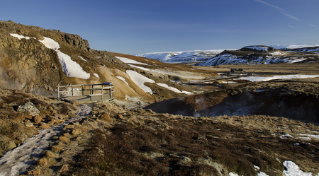 Iceland is a land of ice and fire. In the geothermal area Kerlingarfjoll one can see smoke and boiling fumaroles from the geothermal field as well as mountains covered by ice and snow.の写真素材