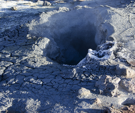 Fumarole fields of Iceland covered with yellow brimstone with boiling mud craters against the winter skyの写真素材