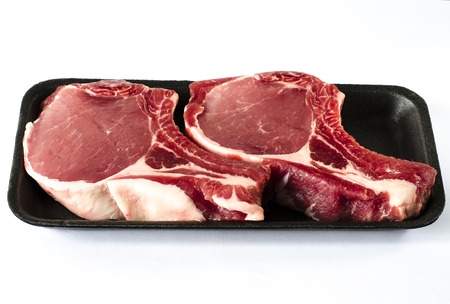 Top view of black foam food tray with Raw marbled meat steak isolated on whiteの写真素材