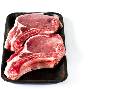 Top view of black foam food tray with Raw marbled meat steak isolated on whiteの写真素材