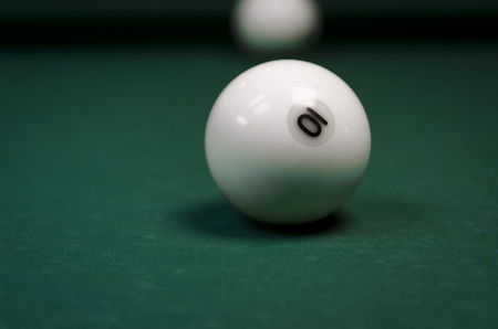 White billiard balls covered on a table with a green clothの写真素材