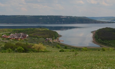 Huge sheer stone cliffs on the background of a river Dniester and a blue sky with clouds. Ukraineの写真素材