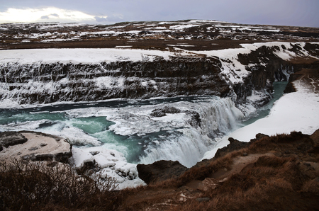 Hraunfossar, a waterfall formed by rivulets streaming over Hallmundarhraun, a lava field from volcano lying under the glacier Langjokull, and pour into the Hvita river, Icelandの写真素材