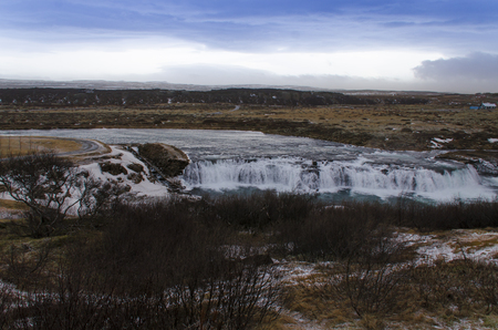 Hraunfossar, a waterfall formed by rivulets streaming over Hallmundarhraun, a lava field from volcano lying under the glacier Langjokull, and pour into the Hvita river, Icelandの写真素材