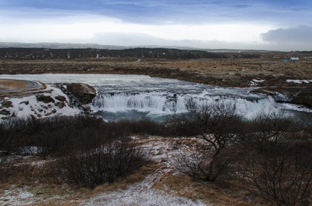 Hraunfossar, a waterfall formed by rivulets streaming over Hallmundarhraun, a lava field from volcano lying under the glacier Langjokull, and pour into the Hvita river, Icelandの写真素材