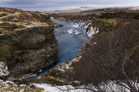 Hraunfossar, a waterfall formed by rivulets streaming over Hallmundarhraun, a lava field from volcano lying under the glacier Langjokull, and pour into the Hvita river, Icelandの写真素材
