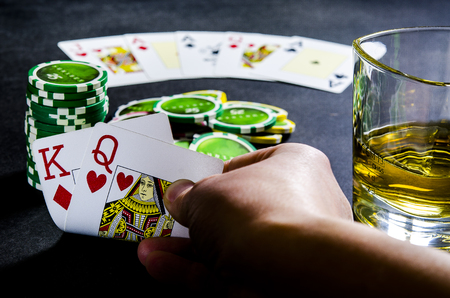 Person playing poker and looking at cardsのeditorial素材