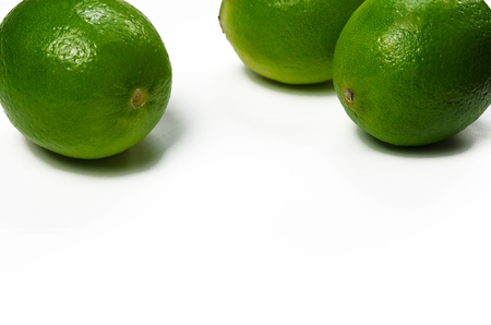 Juicy green limes are on a white background with copy space top viewの写真素材