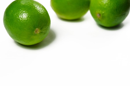 Juicy green limes are on a white background with copy space top viewの写真素材
