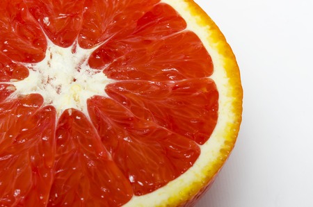 cut juicy red orange close-up lies on a white background with copy space top viewの写真素材