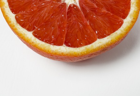 cut juicy red orange close-up lies on a white background with copy space top viewの写真素材