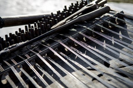 Old wooden stringed musical instrument stands under the open sky. conceptの写真素材