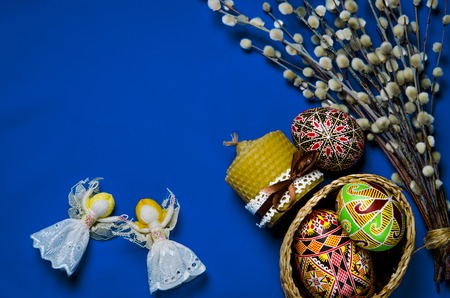 Easter Pussy-willow and Easter egg on blue background. Happy Easter card. with Happy Easter. rustic lacquered Blank picture poster frame template isolated on white backgroundの写真素材