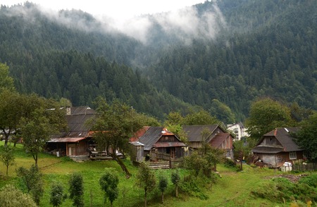 Morning fog in the mountains of the Carpathians on the background of mountain peaks covered with...
