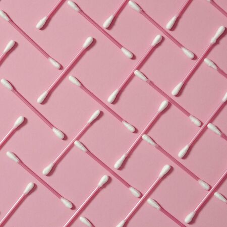 Hygiene: multi-colored plastic cotton buds lie on the yak background. Close-up. Top view, flat lay