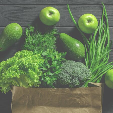 Zero waste concept. Paper bag with various green vegetables top view. Healthy eating concept. Order food onlineの写真素材