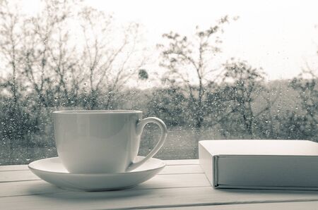 Cozy home still life: Coffee cup over mirror background in rainy day,copy spaceの写真素材