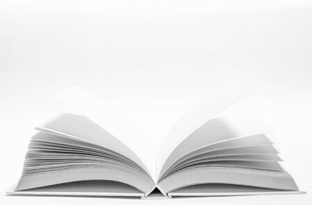 Mockup of opened blank square ctalogue at white design paper background. An open white book rests on a white background. close-upの写真素材