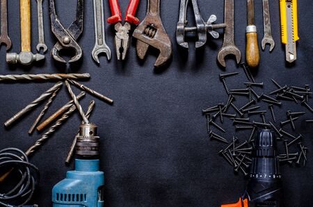 Hand tools for repair and reconstruction in home conditions lie on a black background. copy spaceの写真素材