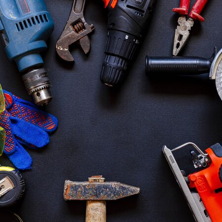 Construction worker tools on a dark background top view. Remodel concept
