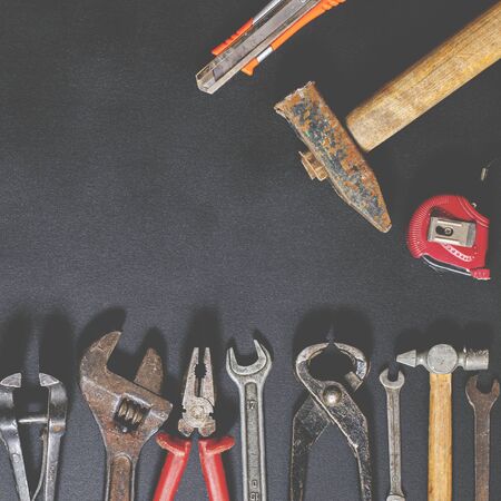 Hand tools for repair and reconstruction in home conditions lie on a black background. copy space