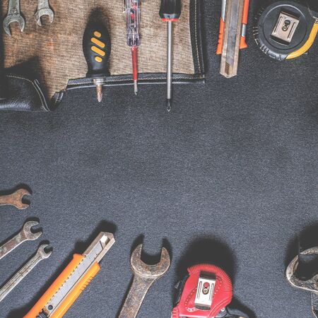 Hand tools for repair and reconstruction in home conditions lie on a black background. copy space