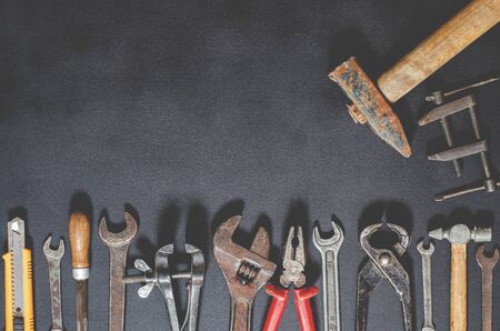 Hand tools for repair and reconstruction in home conditions lie on a black background. copy space