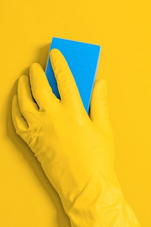 Hand in rubber glove with wipe for cleaning wipes the surface from dust, dirt and bacteria. Commercial cleaning company conceptの写真素材