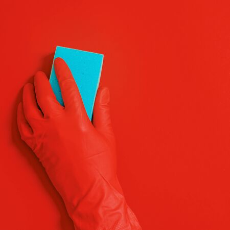 Hand in rubber glove with wipe for cleaning wipes the surface from dust, dirt and bacteria. Commercial cleaning company conceptの写真素材