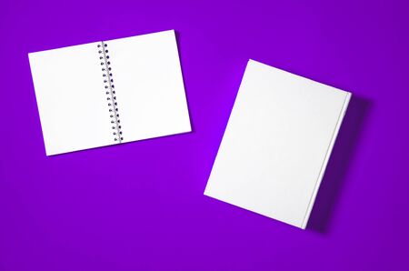 Mockup of closed blank square book at white textured paper background. Blank square cover book template on bright backgroundの写真素材