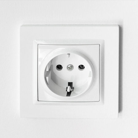 The white plastic socket is mounted in a white wall
