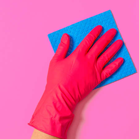 Blue house cleaning sponge in hand in red rubber gloveの写真素材