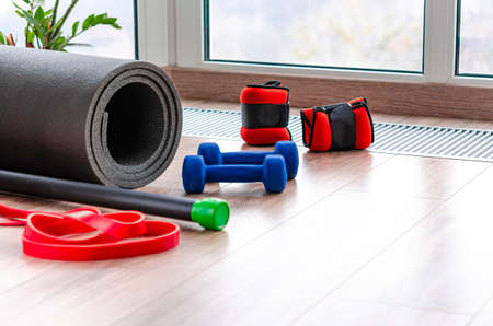 Top view of fitness mat with dumbbells and resistance bandの写真素材