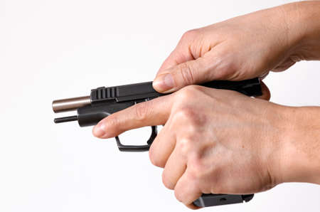 Pistol, or Auto-Loader Short gun in females hand preparing or self loading prompt to useの写真素材