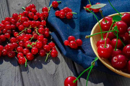 Freshly picked ripe berries of redcurrant close-up on a wooden tableの写真素材