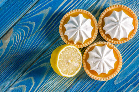 Sweet dessert for tea or coffee. Lemon cakes on a blue wooden tableの写真素材