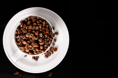 mug with coffee beans. coffee beans on a black background. High quality photoの写真素材